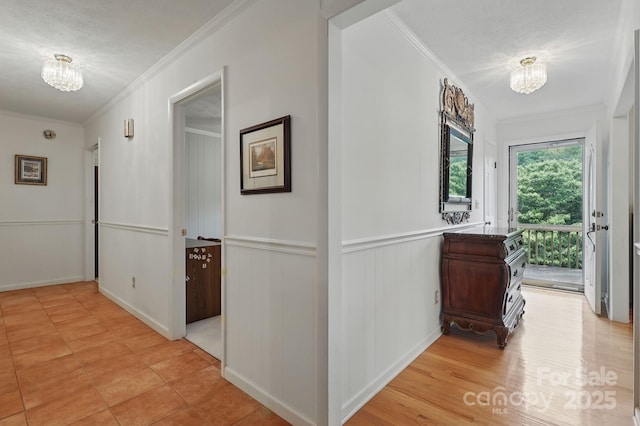 174 Sunny Knoll Ln, Boone, NC 28607 - hall featuring crown molding, a chandelier, and a wainscoted wall