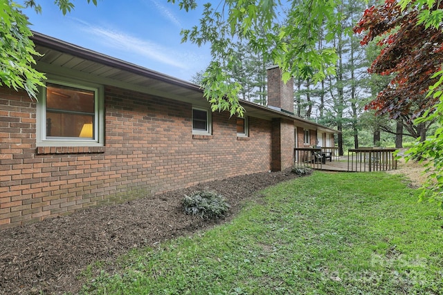 174 Sunny Knoll Ln, Boone, NC 28607 - view of property exterior featuring a chimney, a lawn, a wooden deck, and brick siding