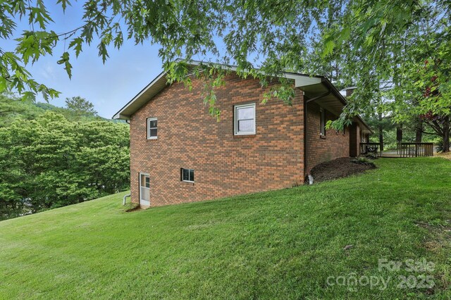 174 Sunny Knoll Ln, Boone, NC 28607 - view of home's exterior featuring a lawn, brick siding, and a wooden deck