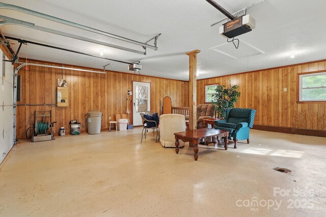 174 Sunny Knoll Ln, Boone, NC 28607 - garage featuring a garage door opener and wooden walls