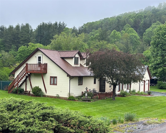 137 Clint Lewis Rd, Boone, NC 28607 - view of front facade with a front lawn, stairs, a view of trees, a garage, and a shingled roof