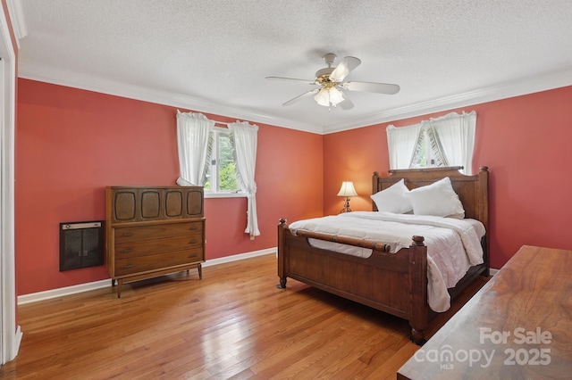 137 Clint Lewis Rd, Boone, NC 28607 - bedroom featuring light wood finished floors, baseboards, crown molding, a textured ceiling, and a ceiling fan