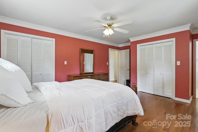 137 Clint Lewis Rd, Boone, NC 28607 - bedroom featuring ornamental molding, multiple closets, wood finished floors, baseboards, and a ceiling fan