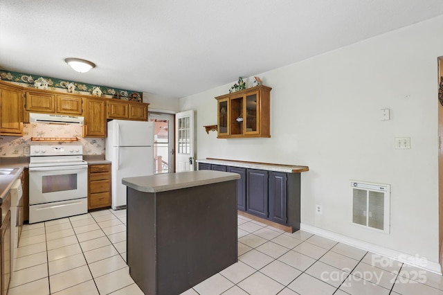 137 Clint Lewis Rd, Boone, NC 28607 - kitchen with white appliances, exhaust hood, light tile patterned floors, a center island, and brown cabinetry