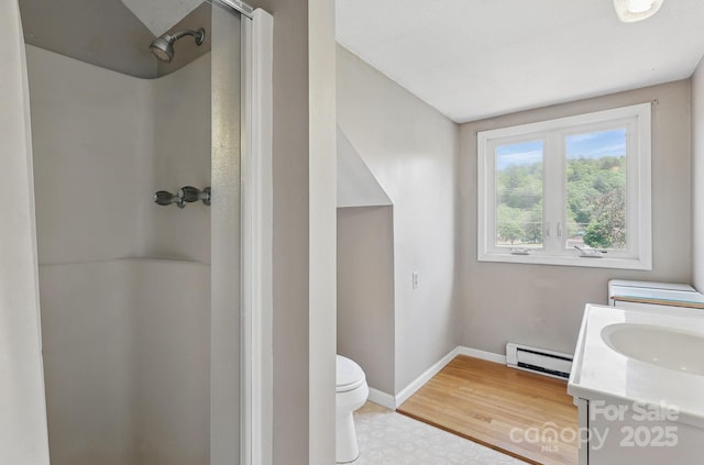 137 Clint Lewis Rd, Boone, NC 28607 - full bathroom featuring a baseboard heating unit, toilet, a shower, baseboards, and vanity