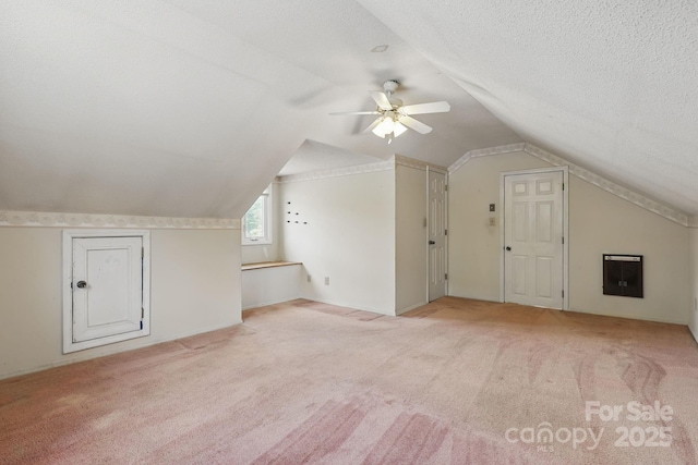 137 Clint Lewis Rd, Boone, NC 28607 - additional living space featuring carpet floors, ceiling fan, vaulted ceiling, a textured ceiling, and heating unit