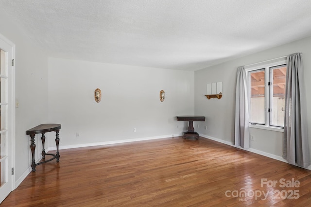 137 Clint Lewis Rd, Boone, NC 28607 - unfurnished room with wood finished floors, baseboards, and a textured ceiling