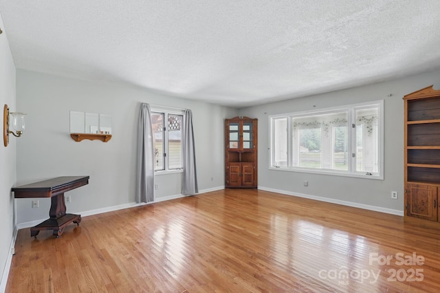 137 Clint Lewis Rd, Boone, NC 28607 - foyer with a textured ceiling, healthy amount of natural light, wood finished floors, and baseboards