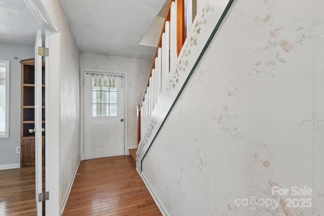 137 Clint Lewis Rd, Boone, NC 28607 - doorway to outside featuring stairway, wood-type flooring, baseboards, and a textured ceiling