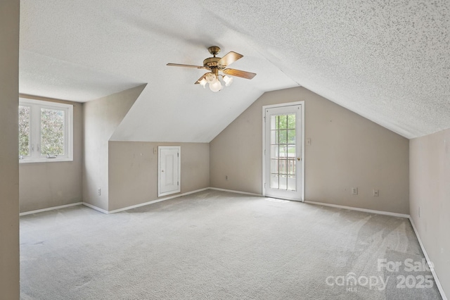137 Clint Lewis Rd, Boone, NC 28607 - additional living space with a textured ceiling, carpet floors, vaulted ceiling, a ceiling fan, and baseboards