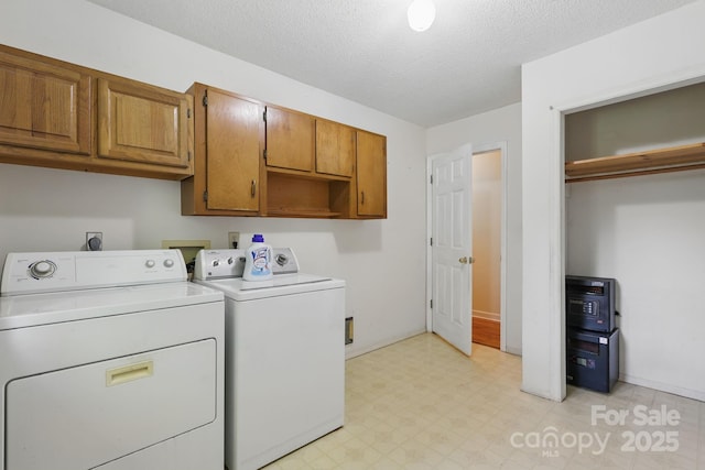 137 Clint Lewis Rd, Boone, NC 28607 - washroom with separate washer and dryer, cabinet space, light flooring, and a textured ceiling