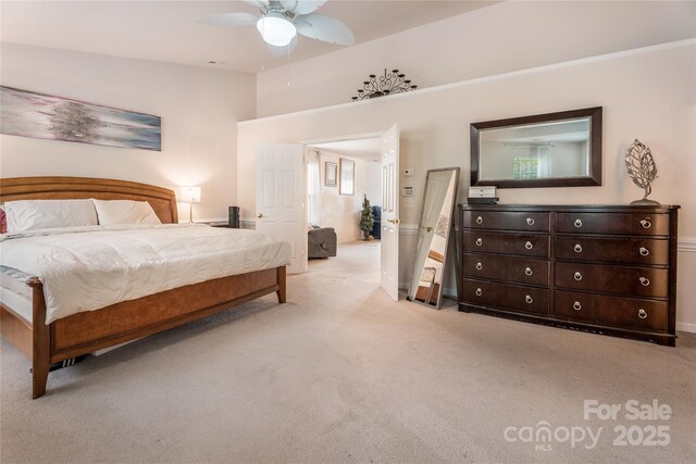 bedroom with light colored carpet, ceiling fan, crown molding, and baseboards