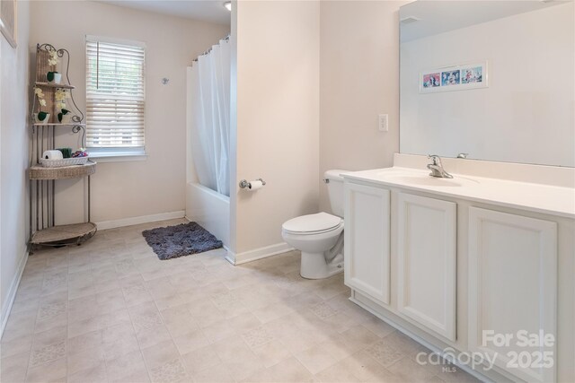 bathroom with shower / tub combo, vanity, toilet, and baseboards