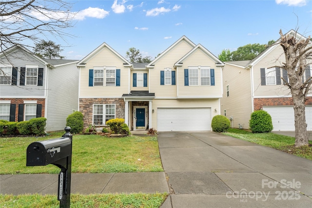 multi unit property featuring a garage, a front yard, concrete driveway, and stone siding