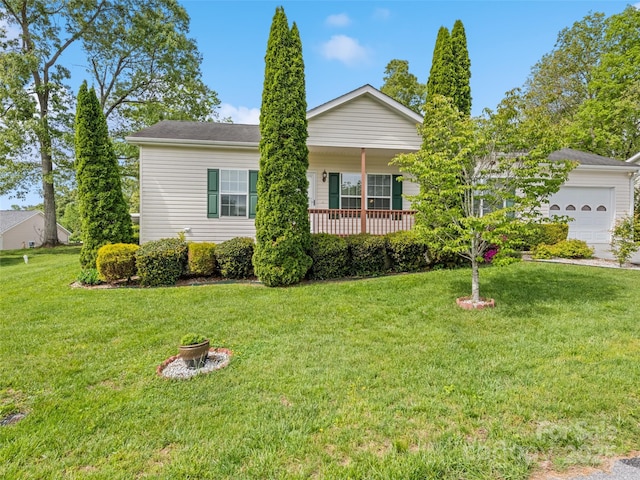 view of front of home featuring an attached garage, a front lawn, and a porch