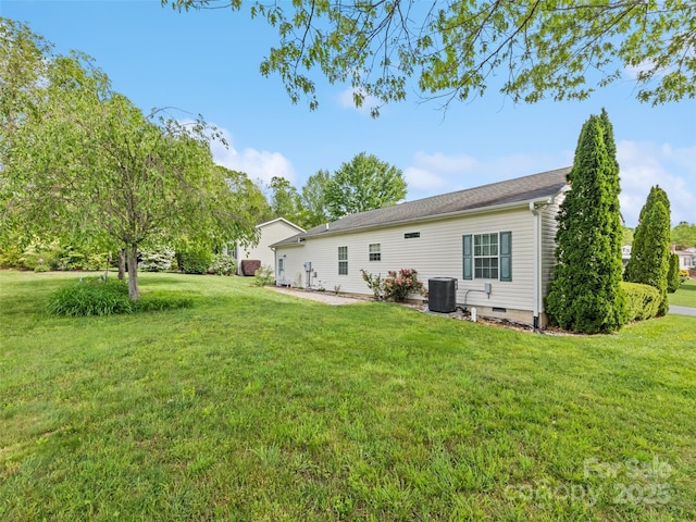 back of house with central air condition unit, a lawn, and crawl space