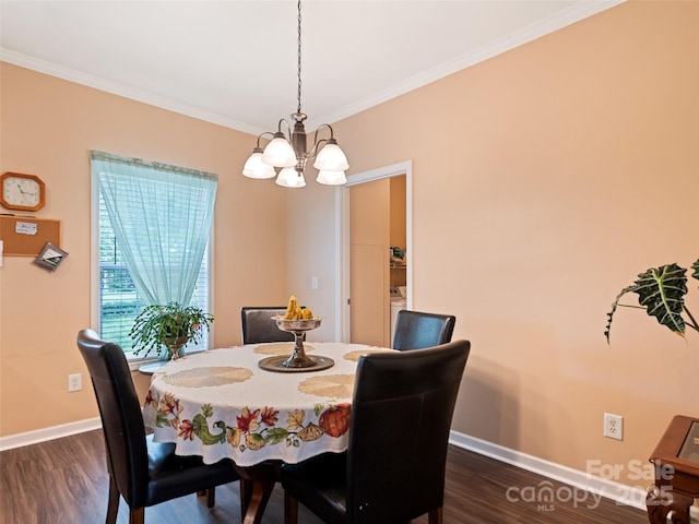 dining area featuring a chandelier, ornamental molding, dark wood finished floors, and baseboards