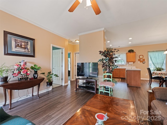 living room featuring ornamental molding, dark wood-type flooring, ceiling fan, baseboards, and recessed lighting