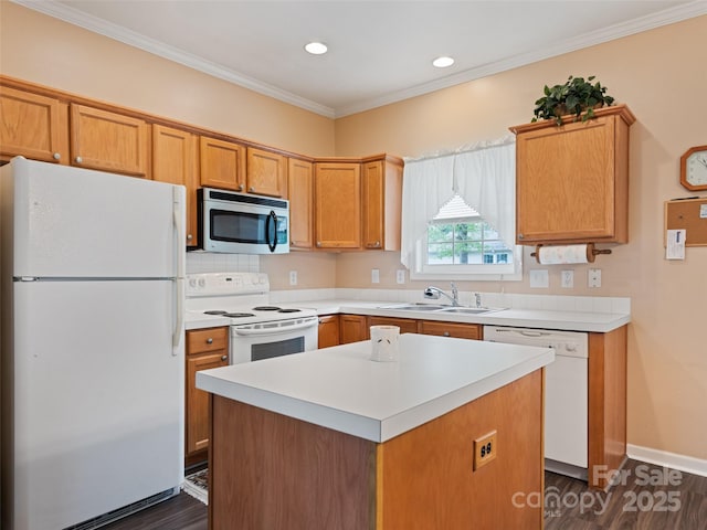 kitchen with white appliances, a sink, dark wood-style floors, light countertops, and a kitchen island