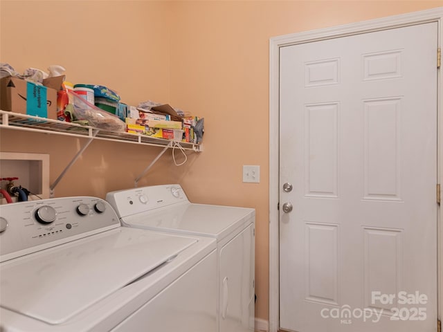 washroom with washing machine and clothes dryer