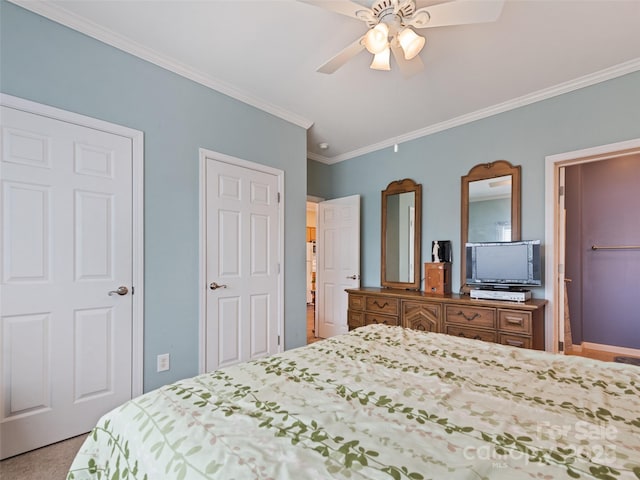 bedroom featuring ornamental molding, ceiling fan, and carpet flooring