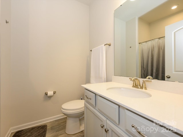 1516 Laggan Ln, Indian Trail, NC 28079 - full bathroom with wood finished floors, baseboards, toilet, vanity, and recessed lighting