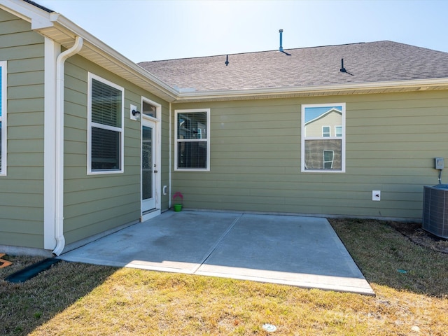 1516 Laggan Ln, Indian Trail, NC 28079 - rear view of house with a patio, central AC unit, a yard, and a shingled roof