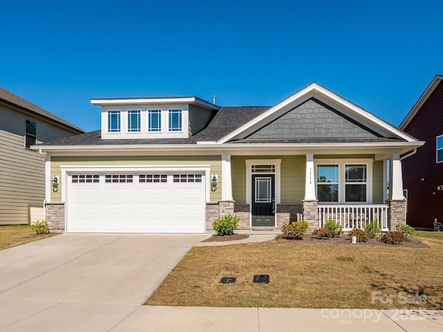 1516 Laggan Ln, Indian Trail, NC 28079 - craftsman-style home with stone siding, a porch, concrete driveway, and a front lawn