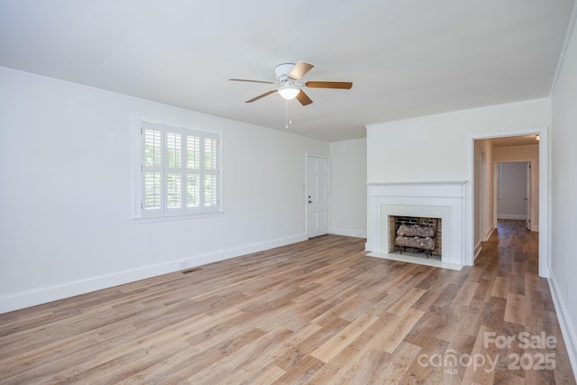 402 Hudson St, Winnsboro, SC 29180 - unfurnished living room with light wood finished floors, a brick fireplace, a ceiling fan, and visible vents
