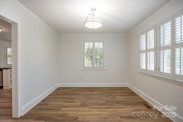 402 Hudson St, Winnsboro, SC 29180 - spare room featuring wood finished floors, visible vents, baseboards, and ornamental molding