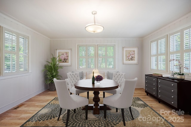 402 Hudson St, Winnsboro, SC 29180 - dining room with light wood-style flooring, visible vents, baseboards, and ornamental molding