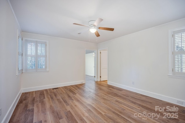 402 Hudson St, Winnsboro, SC 29180 - unfurnished room with wood finished floors, ornamental molding, baseboards, and ceiling fan