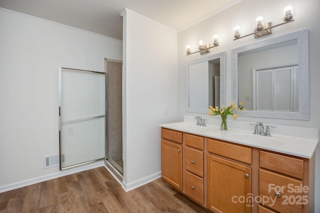 402 Hudson St, Winnsboro, SC 29180 - bathroom featuring a sink, double vanity, visible vents, wood finished floors, and ornamental molding