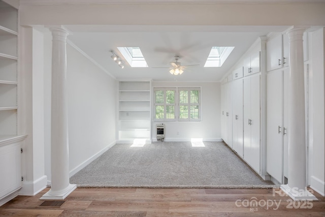 402 Hudson St, Winnsboro, SC 29180 - unfurnished living room with a skylight, baseboards, wood finished floors, and built in features