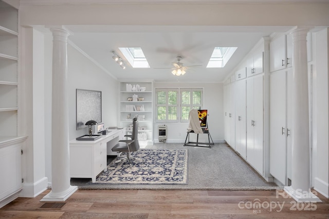 402 Hudson St, Winnsboro, SC 29180 - office space featuring crown molding, wood finished floors, lofted ceiling with skylight, built in shelves, and baseboards