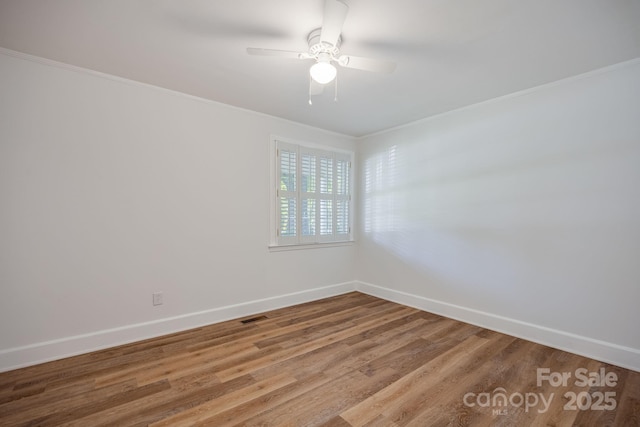 402 Hudson St, Winnsboro, SC 29180 - empty room featuring wood finished floors, visible vents, a ceiling fan, crown molding, and baseboards