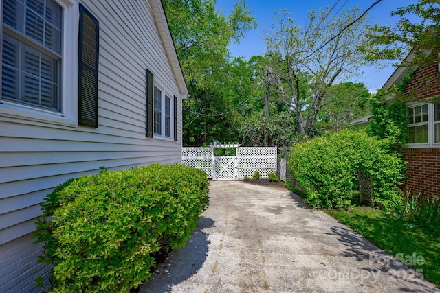 402 Hudson St, Winnsboro, SC 29180 - view of side of property featuring fence, a patio area, and driveway