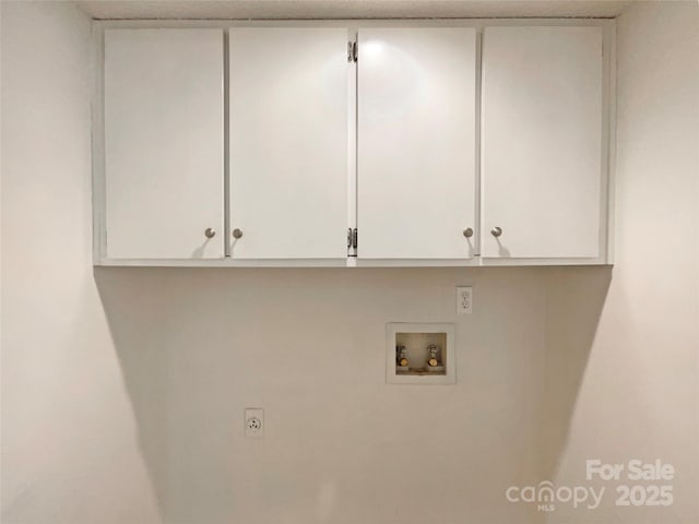 clothes washing area featuring electric dryer hookup, cabinet space, and hookup for a washing machine