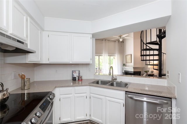 kitchen featuring backsplash, under cabinet range hood, stainless steel appliances, and a sink