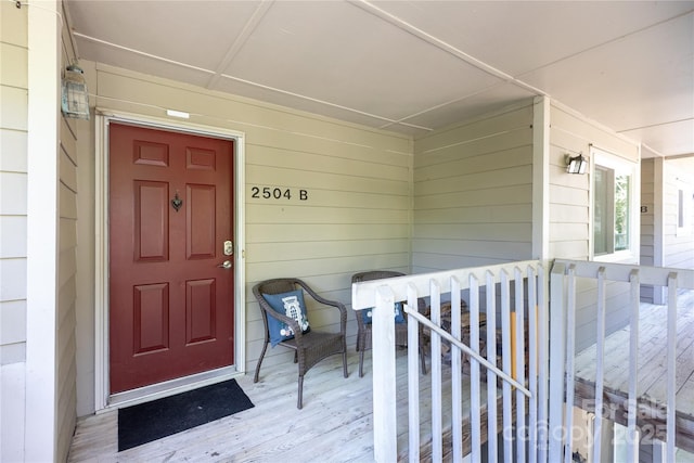view of exterior entry featuring covered porch