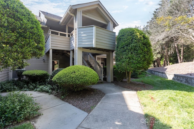view of front of property with a front lawn and stairway