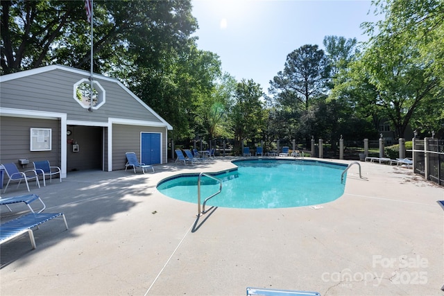 pool with fence and a patio