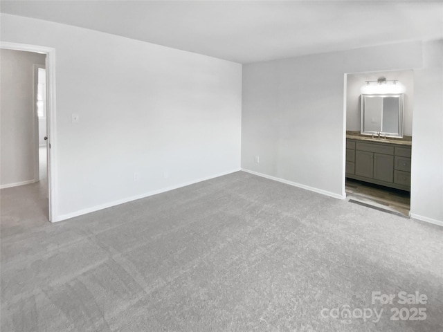 8026 Regent Park Ln, Charlotte, NC 28210 - unfurnished bedroom featuring a sink, carpet floors, baseboards, and ensuite bathroom