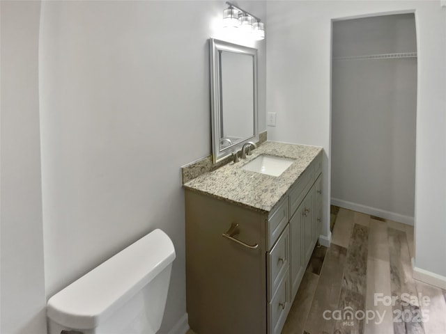 8026 Regent Park Ln, Charlotte, NC 28210 - bathroom featuring wood finished floors, vanity, toilet, and baseboards