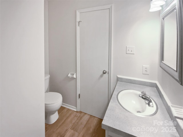 8026 Regent Park Ln, Charlotte, NC 28210 - bathroom with toilet, vanity, and wood finished floors