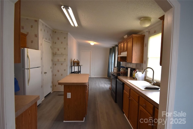 234 Olin Loop, Olin, NC 28660 - kitchen featuring a center island, freestanding refrigerator, dark wood finished floors, a textured ceiling, and light countertops