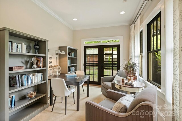 sitting room with carpet flooring, ornamental molding, and french doors