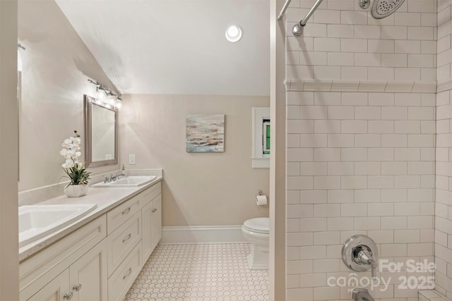full bath with toilet, a sink, and double vanity