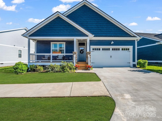231 Leyland Cir, Hendersonville, NC 28792 - craftsman house featuring a garage, a porch, concrete driveway, and a front yard