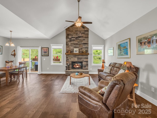 231 Leyland Cir, Hendersonville, NC 28792 - living area featuring a ceiling fan, dark wood finished floors, baseboards, a stone fireplace, and a chandelier